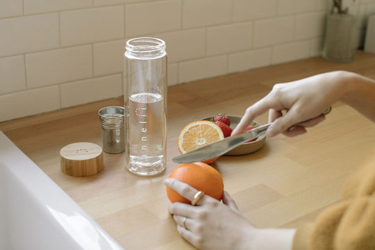 A Reusable Drinking Vessel Surrounded With Fruit For Infusing